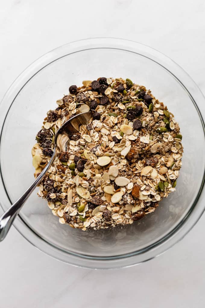 a bowl with oats, nuts and seeds in it
