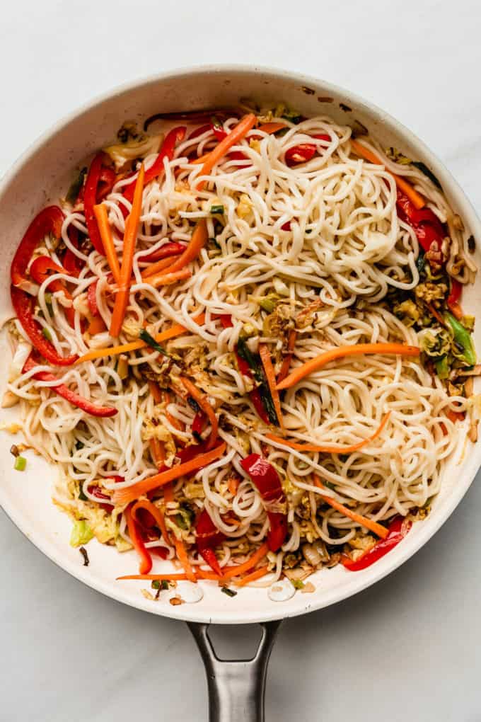 noodles and vegetables in a white pan