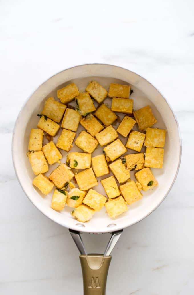 cubed crispy tofu in a white pan