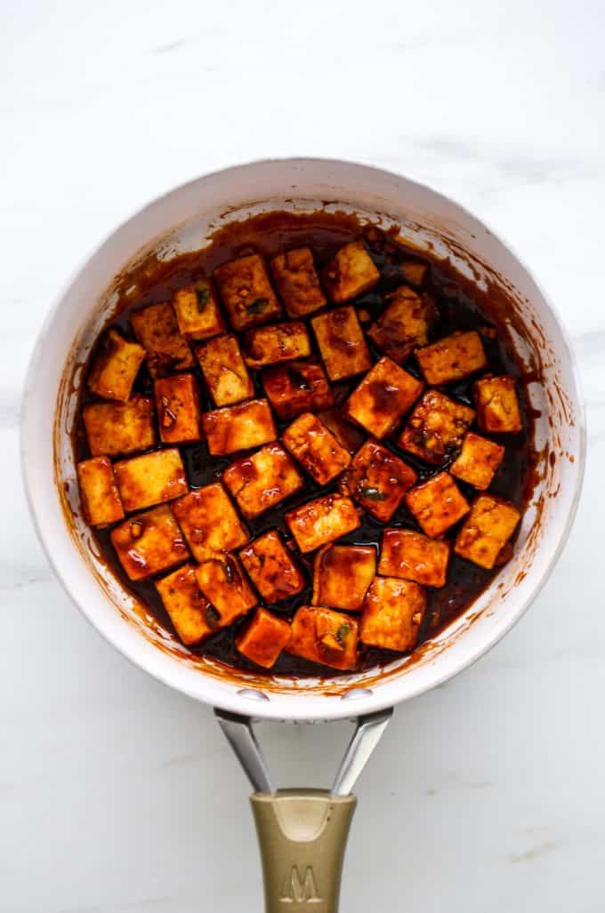 general tso's tofu in a white pan
