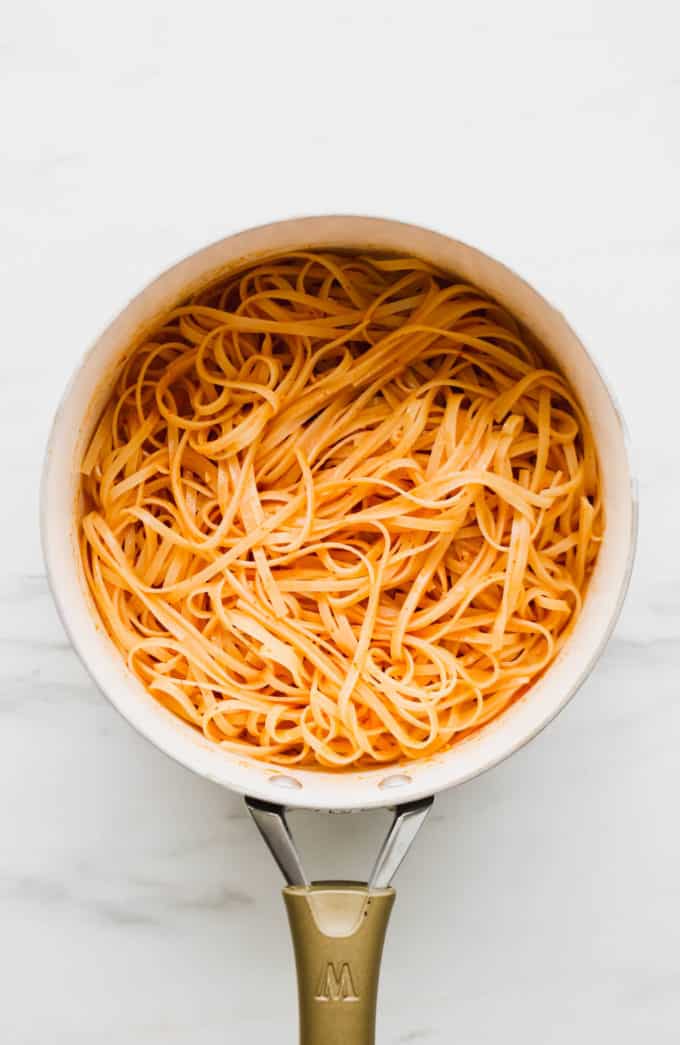 Curry sauce and noodles in a white pan