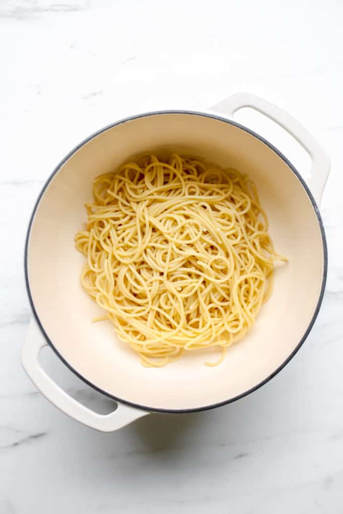 A white pot with noodles in it