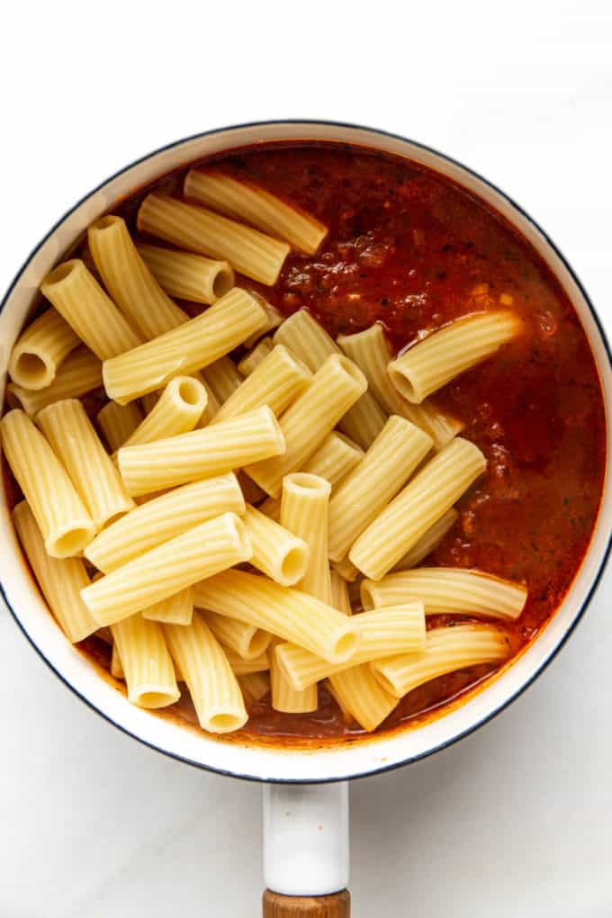 tomato sauce and ziti noodles in a pot