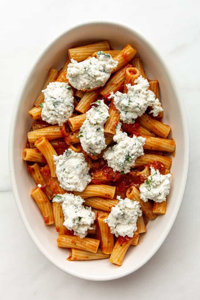 ziti noodles, tomato sauce and ricotta in a baking dish