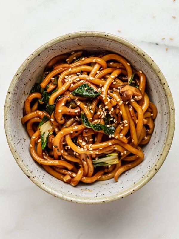 A bowl of yaki udon noodles topped with sesame seeds