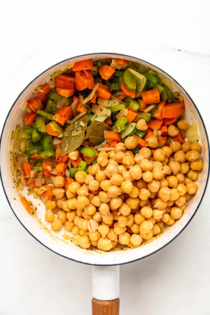 chickpeas and chopped vegetables in a white pot