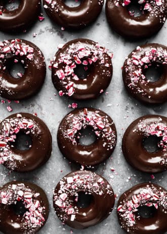 Mocha donuts with chocolate glaze and crushed candy canes on them