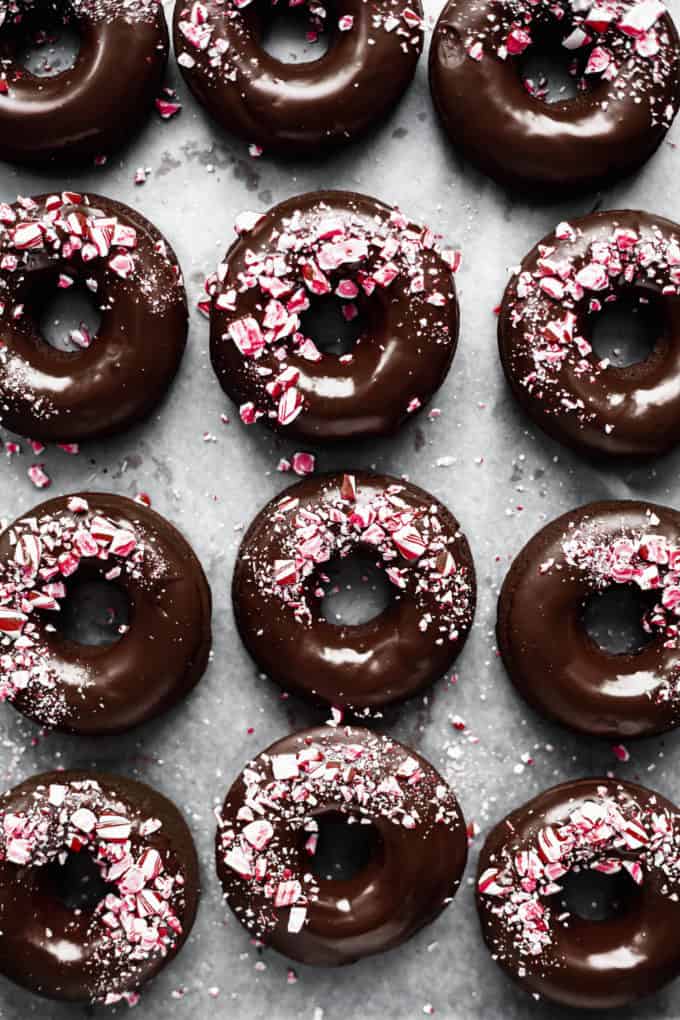 Mocha donuts with chocolate glaze and crushed candy canes on them