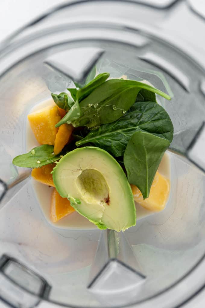 avocado, mango and spinach in a blender