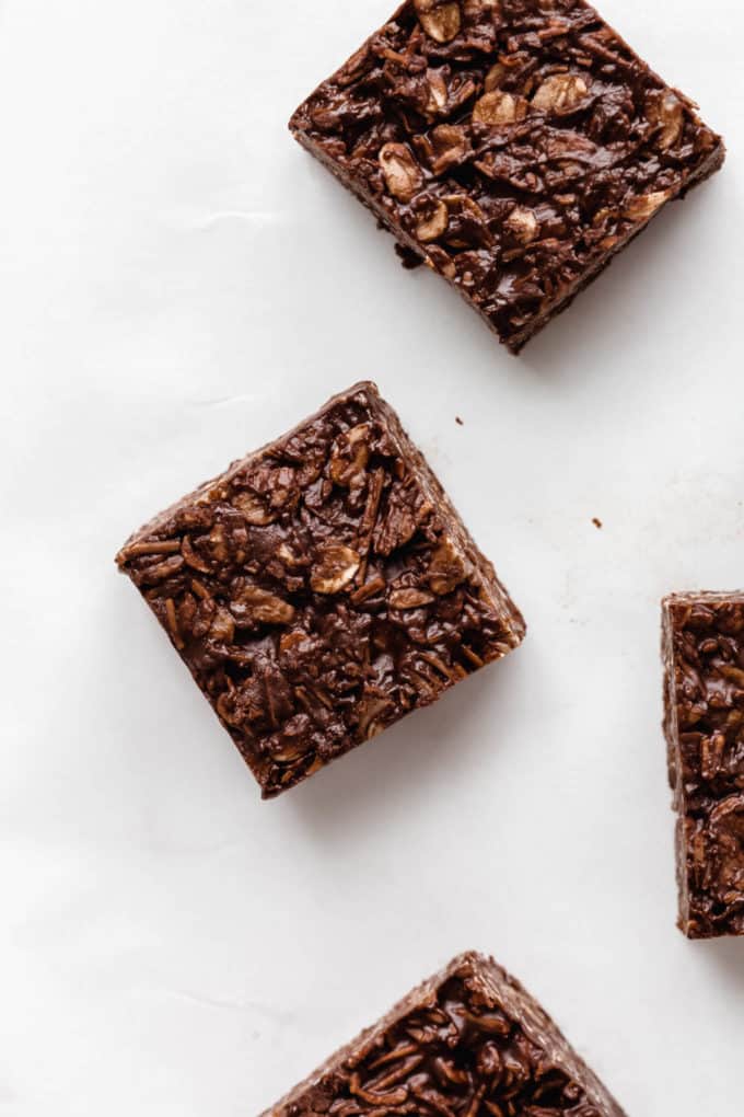 cut up chocolate coconut bars on a marble board
