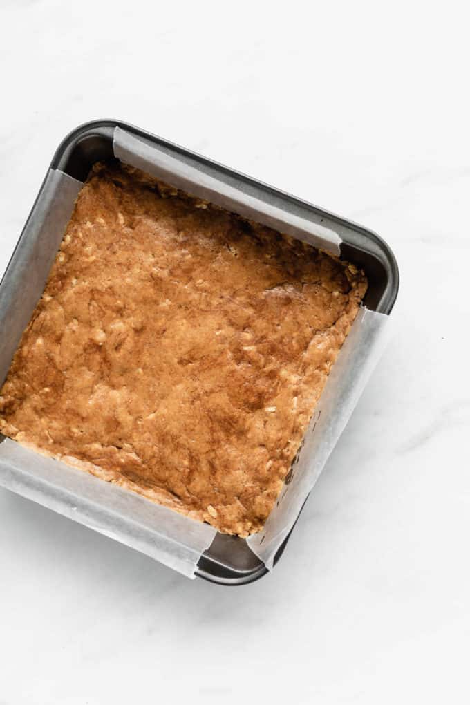 peanut butter protein bar dough in an 8x8 inch pan
