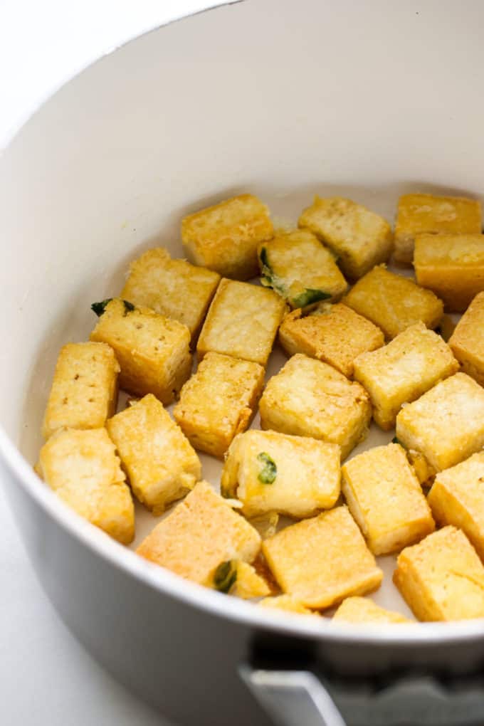 pan fried cubes of tofu in a pan