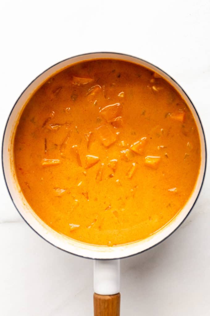 cooked sweet potato curry in a white pot