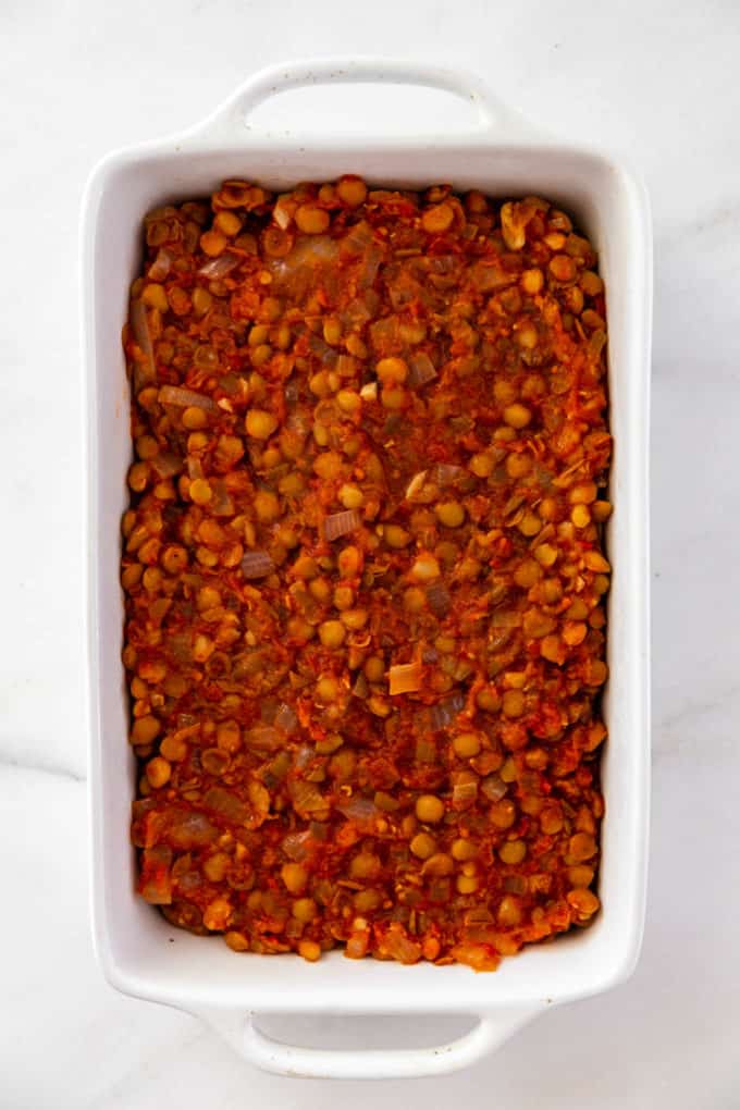 stewed lentils layered in a baking dish