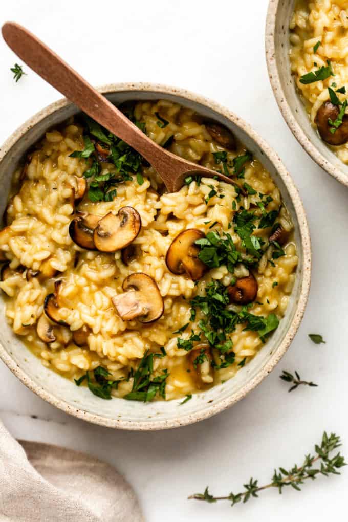 Vegan mushroom risotto in a bowl topped with chopped parsley