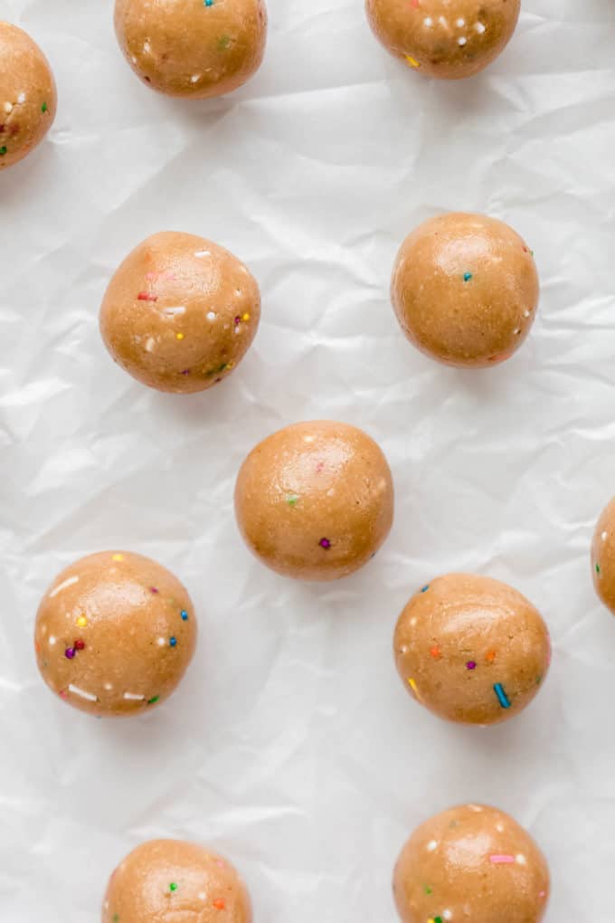 birthday cake protein balls on parchment paper