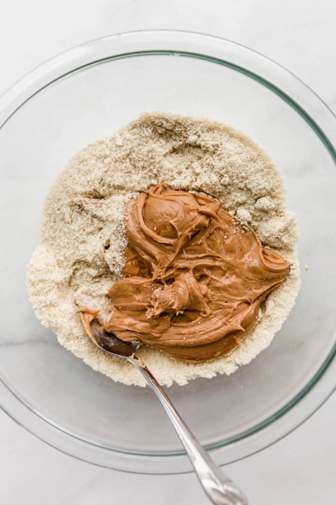 almond flour, protein powder and cashew butter in a clear mixing bowl