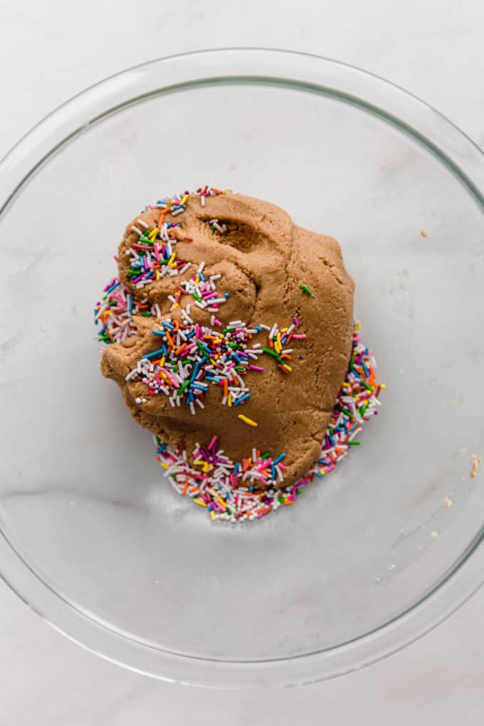 protein ball dough and sprinkles in a mixing bowl