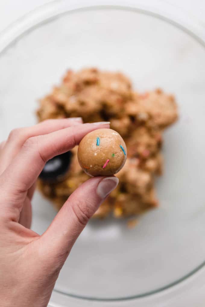a hand holding a protein ball