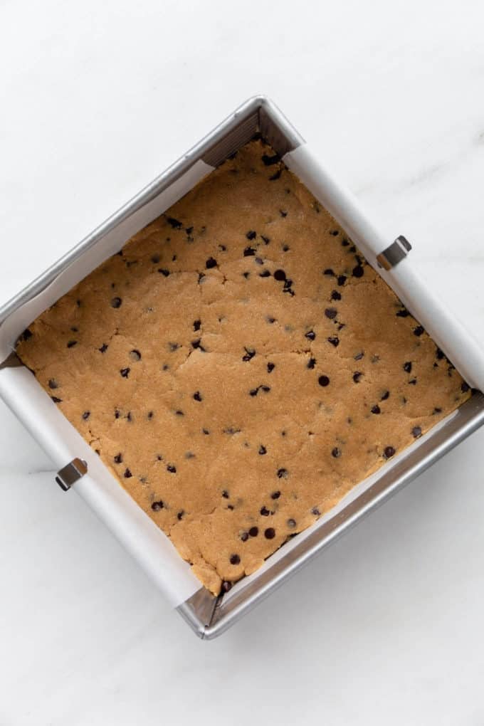 no bake cookie dough pressed into an 8x8 inch pan
