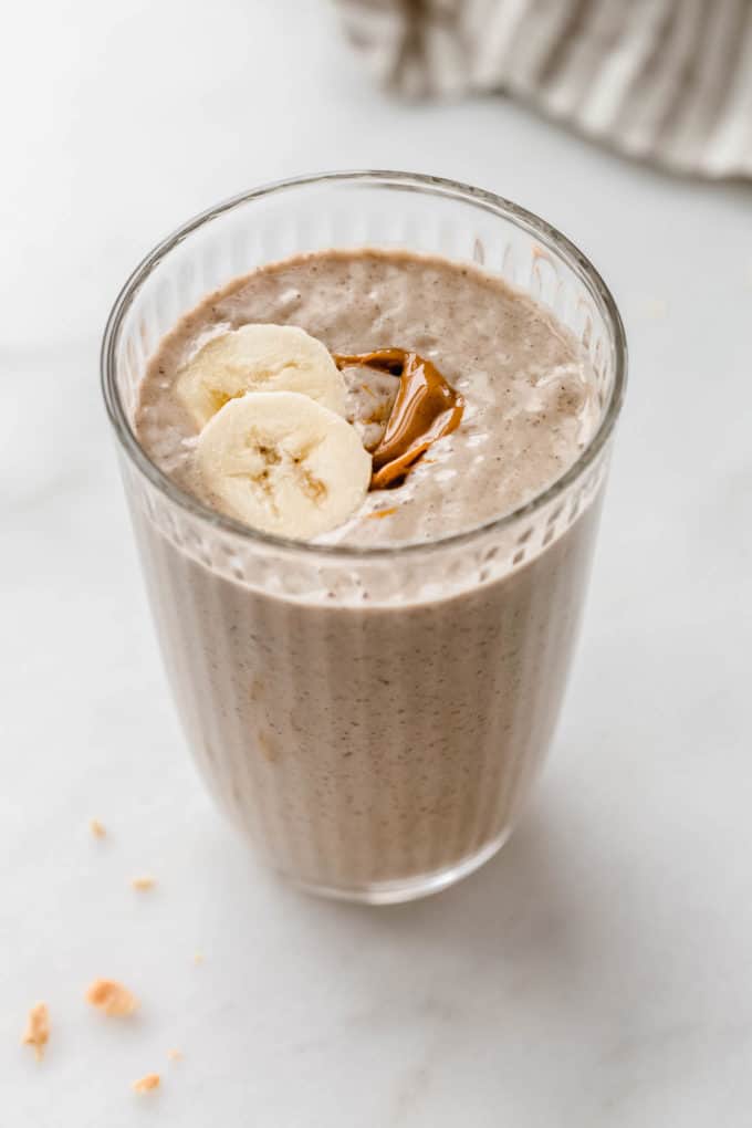 a glass of a peanut butter banana smoothie