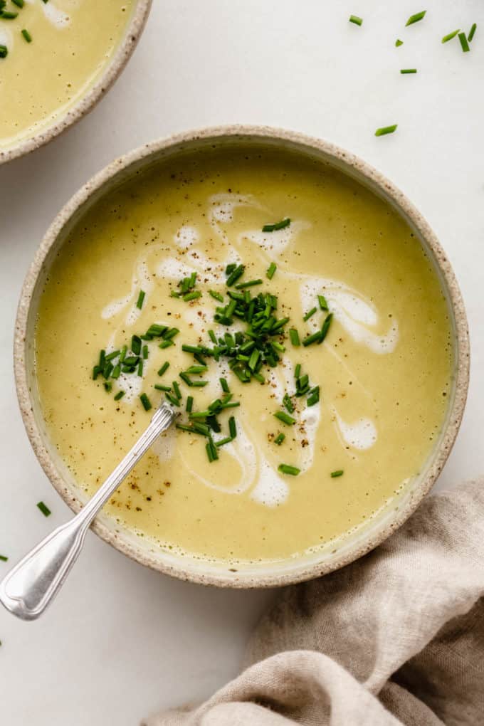 Blended creamy vegan broccoli soup in a ceramic bowl