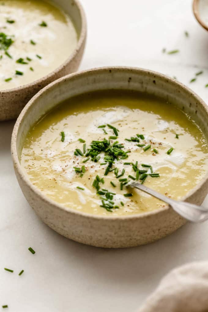 Creamy vegan broccoli soup in a bowl with a spoon