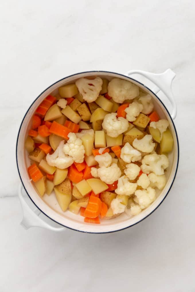 cauliflower, potatoes and carrots in a pot of water