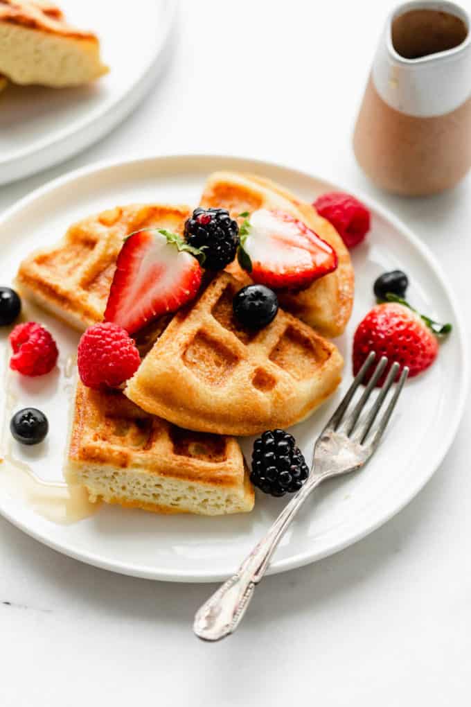 Almond flour waffles on a white plate with berries