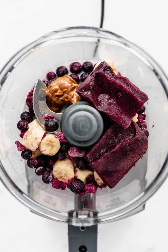 Acai, bananas, berries and almond butter in a food processor