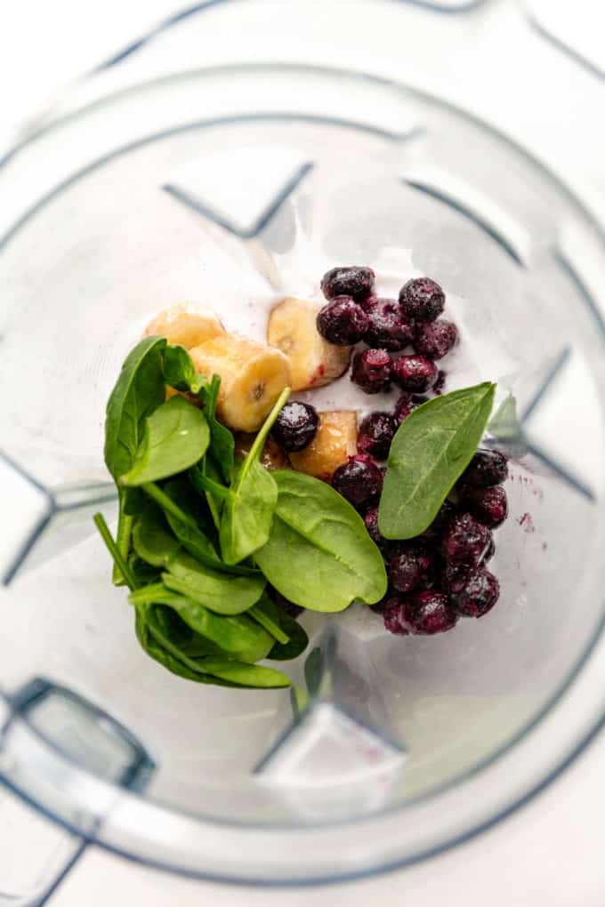blueberries, bananas and spinach in a blender
