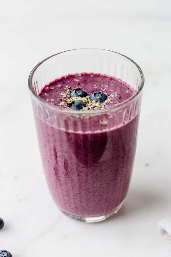A blueberry spinach smoothie in a glass