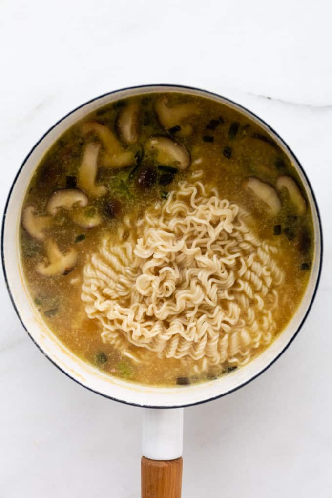 miso ramen soup with ramen noodles in a white pot