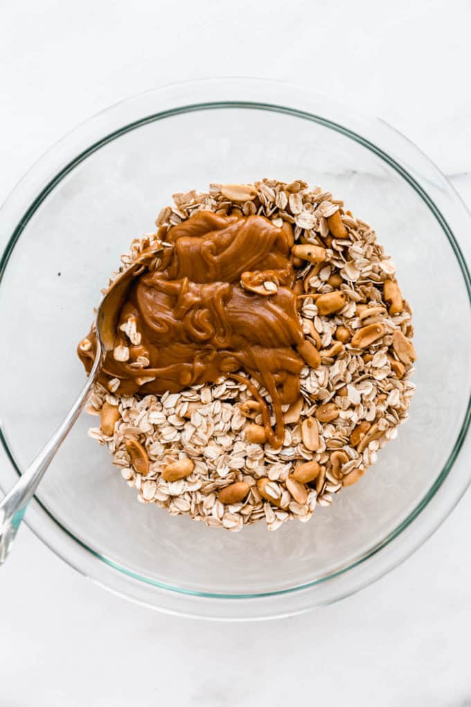 oats, peanuts and peanut butter in a mixing bowl