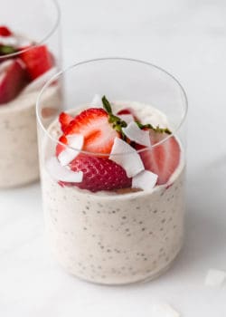 a cup of protein overnight oats topped with strawberries