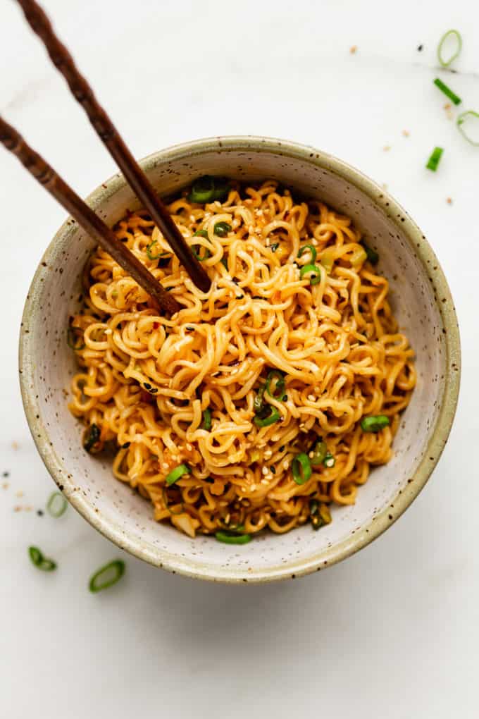 Spicy noodles in a bowl with chopsticks