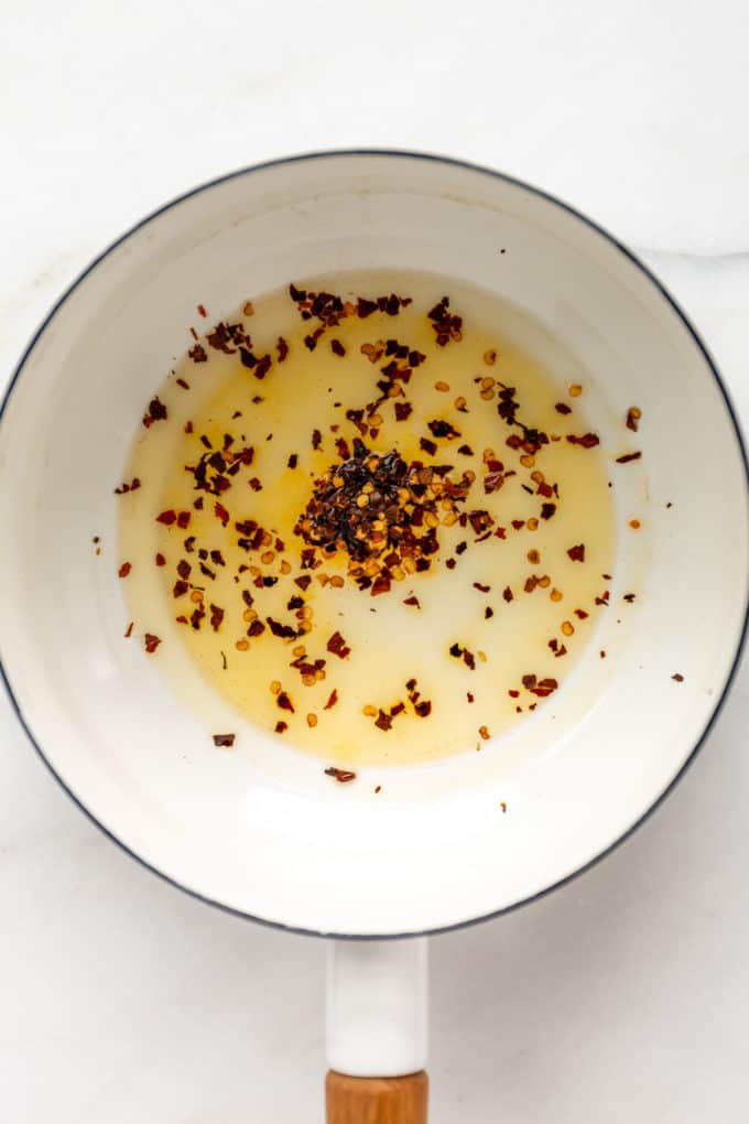 Oil and chili flakes in a white pot