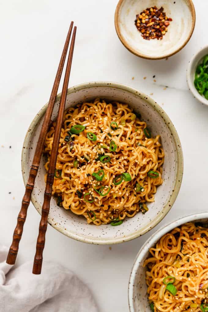 A bowl of spicy chili oil noodles with wood chopsticks