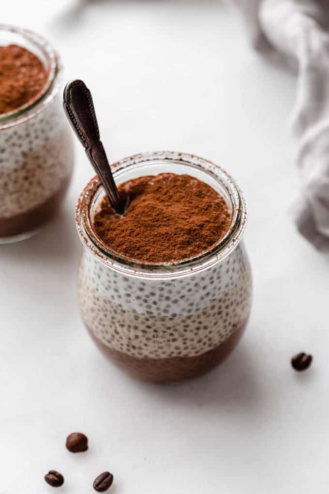 a cup of tiramisu chia pudding topped with cocoa powder