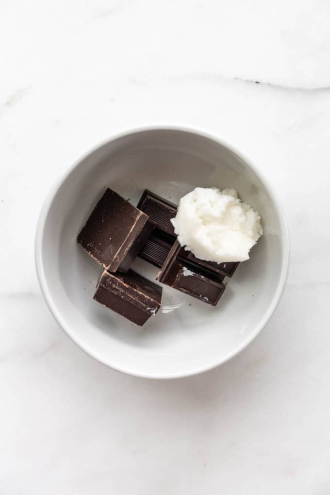 dark chocolate and coconut oil in a white bowl