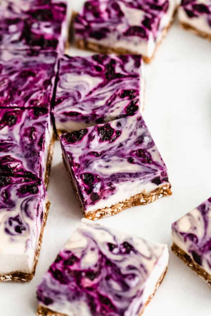 squares of vegan cheesecake with blueberry swirl on top