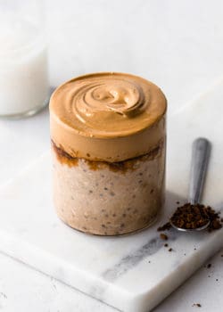 a cup of coffee overnight oats topped with a whipped coffee cream