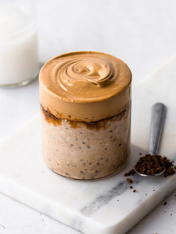 a cup of coffee overnight oats topped with a whipped coffee cream