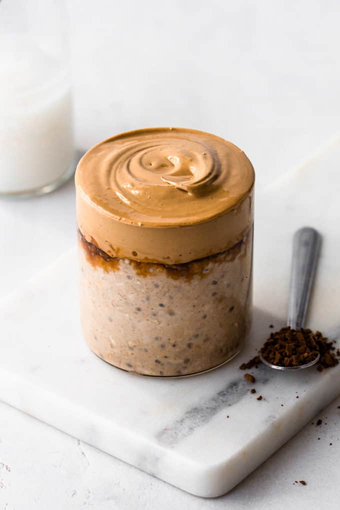 a cup of coffee overnight oats topped with a whipped coffee cream
