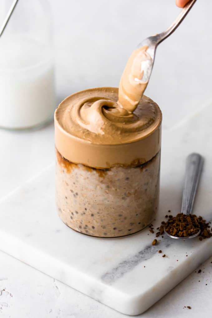 coffee overnight oats with a spoon of instant coffee on the side