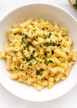 A bowl of lemon fusilli pasta topped with parsley