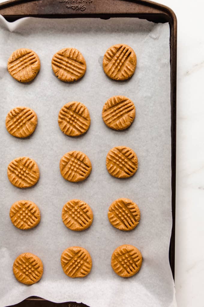 unbaked peanut butter cookies on a baking sheet