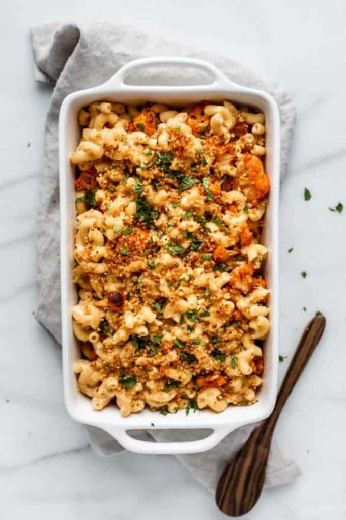 baked mac and cheese with buffalo cauliflower in a white baking dish