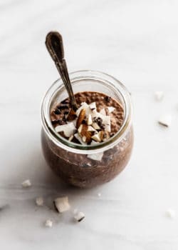 a cup of chocolate chip pudding with a spoon in it