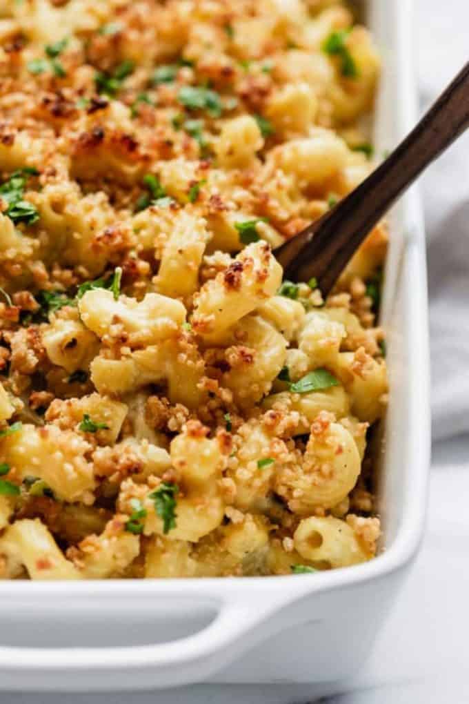 a spoon scooping up jalapeno popper mac and cheese topped with bread crumbs